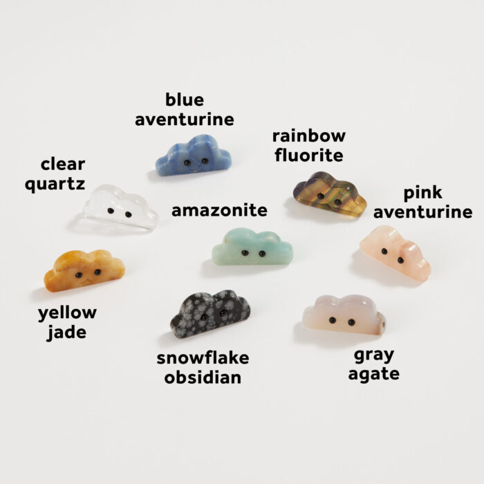 A variety of wholesale carved crystal cloud friends with the stone types labeled: blue aventurine, rainbow fluorite, pink aventurine, amazonite, gray agate, snowflake obsidian, yellow jade, clear quartz