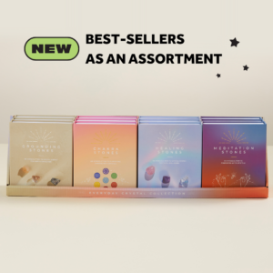 a wholesale display of 12 boxed crystal collections: grounding stones, chakra stones, healing stones, and meditation stones. With text: NEW Best-sellers as an assortment.