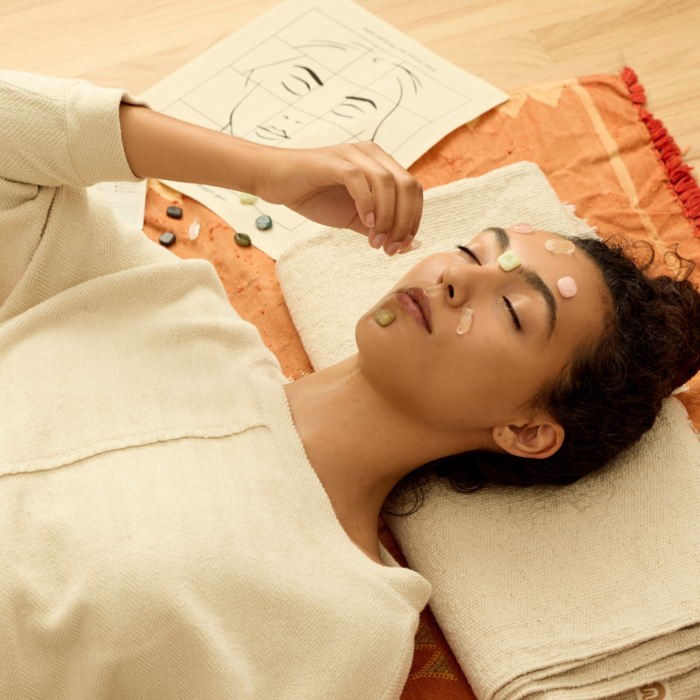 wholesale crystal facial grid on the face of a woman lying with her eyes closed in a home spa setting