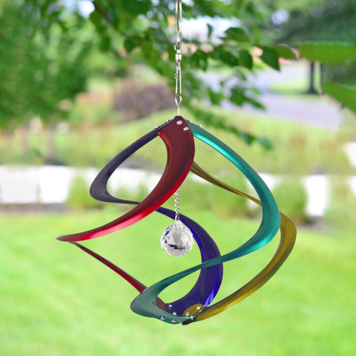 Wholesale hanging garden decor - multicolored wind spinner on blurred outdoor background