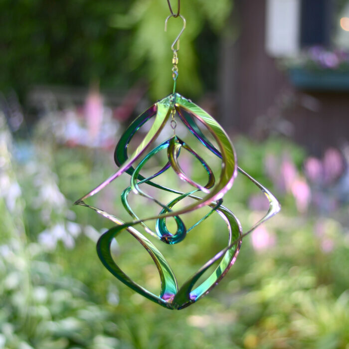 Wholesale hanging garden decor - iridescent wind spinner on blurred outdoor background