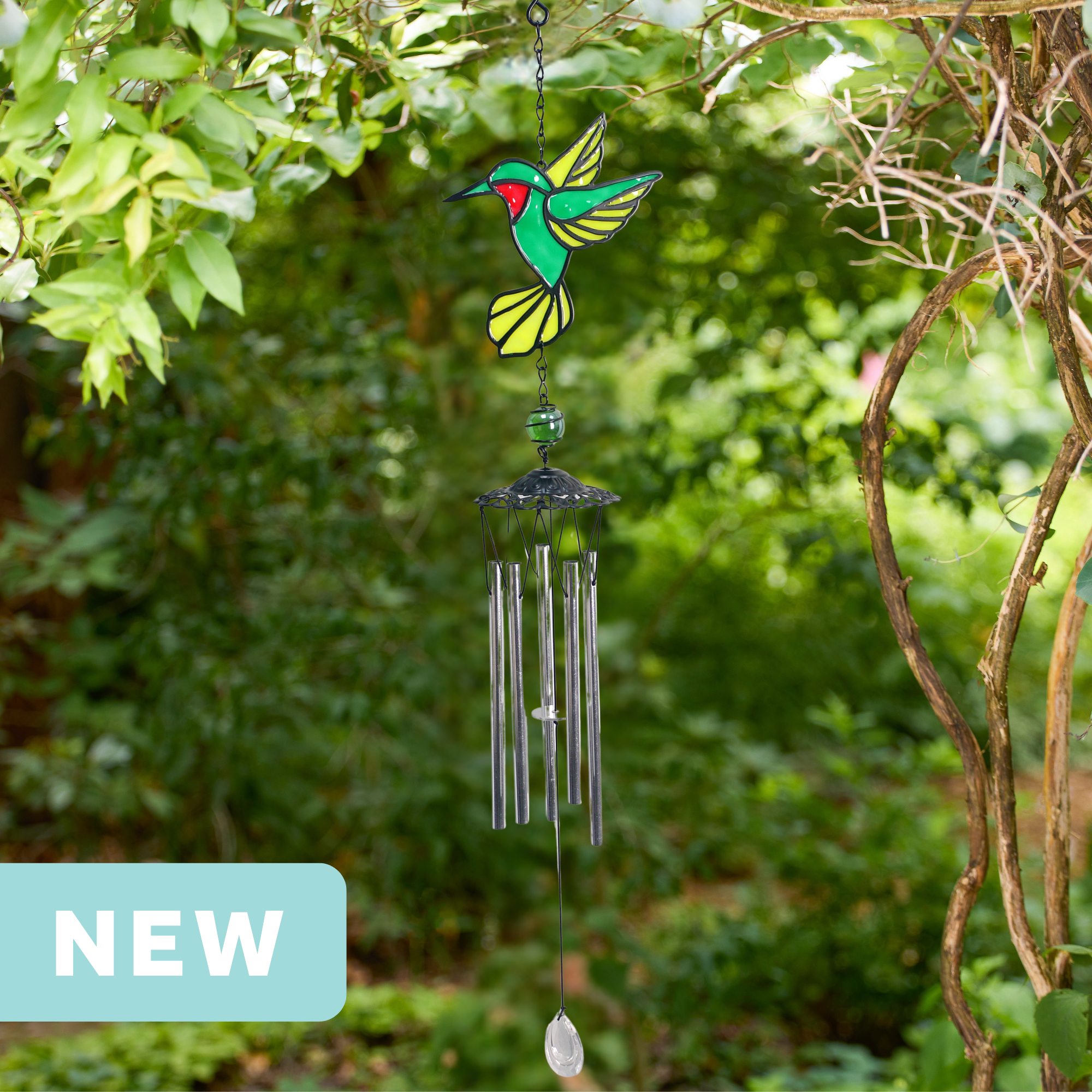 faux stained glass green hummingbird wind chime with silver aluminum chimes and a crystal prism weight hanging outdoors