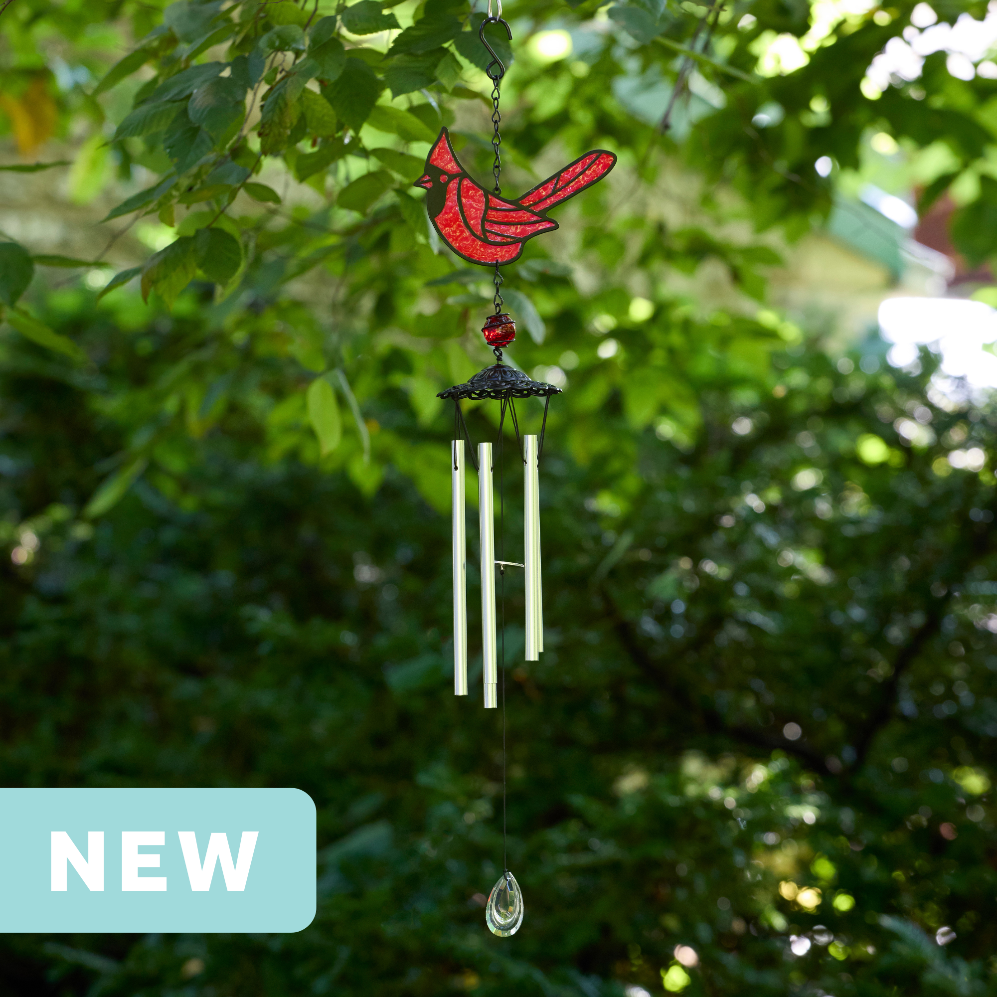 faux stained glass red cardinal wind chime with silver aluminum chimes and a crystal prism weight hanging outdoors