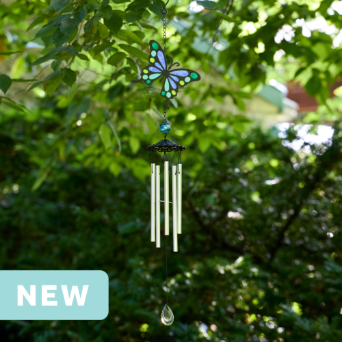 faux stained glass blue and green butterfly wind chime with silver aluminum chimes and a crystal prism weight hanging outdoors