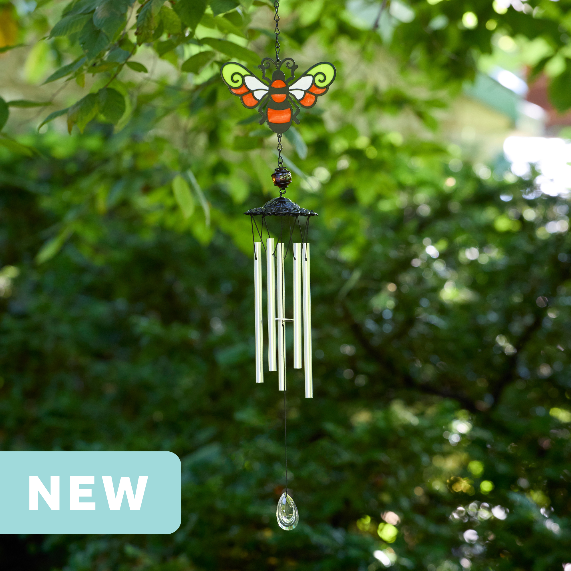 faux stained glass red and yellow and white bumblebee wind chime with silver aluminum chimes and a crystal prism weight hanging outdoors