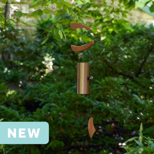 brown single bell wind chime with asymmetrical wood wind sails hanging outdoors