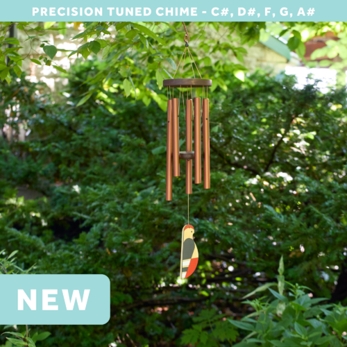 wholesale precision tuned wind chime with a corrosion resistant finish hung outside on a leafy background featuring a wood carved woodpecker as the windsail