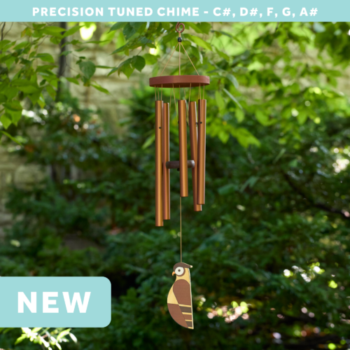 wholesale precision tuned wind chime with a corrosion resistant finish hung outside on a leafy background featuring a wood carved owl as the windsail