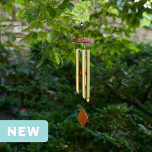 wholesale precision tuned wind chime with a corrosion resistant finish hung outside on a leafy background