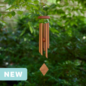 wholesale precision tuned wind chime with a corrosion resistant finish hung outside on a leafy background