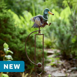 wholesale garden balance rocker featuring a walking mallard duck on a outdoor background with greenery