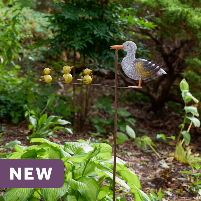 wholesale garden balancer featuring a mother duck and three yellow ducklings on an outdoor background with greenery