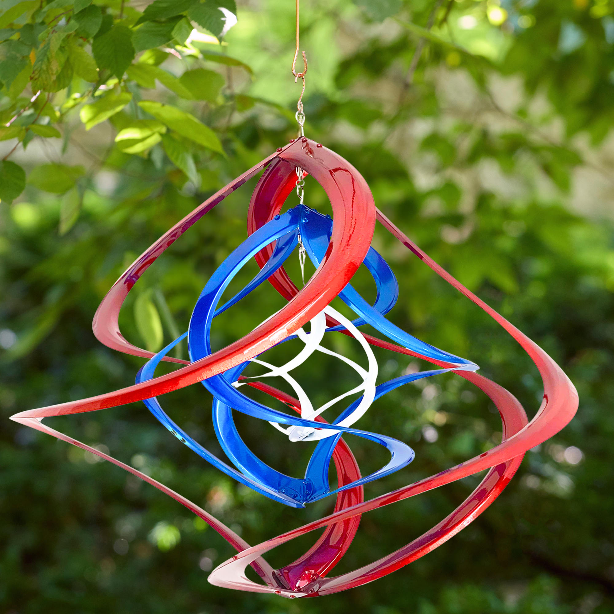 red, white, and blue garden spinner hanging on an outdoor background - wholesale garden.