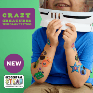 smiling child wearing wholesale space themed kids temporary tattoos - stars, aliens, robots, monsters, astronauts, moons, planets. text reads: Crazy Creatures Temporary Tattoos NEW GeoCentral STEAM