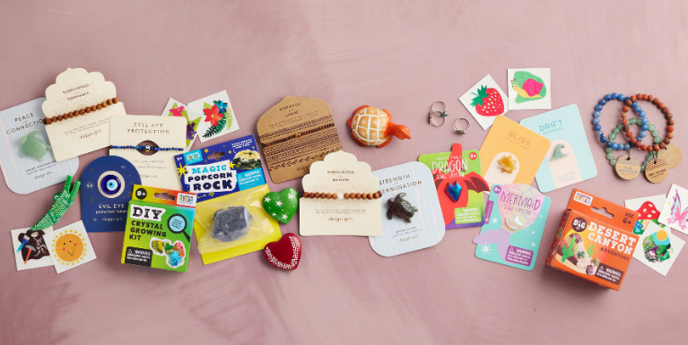 an assortment of new products for 2026 by GeoCentral - jewelry, carved crystals, temporary tattoos, kid's science kits, soapstone figurines