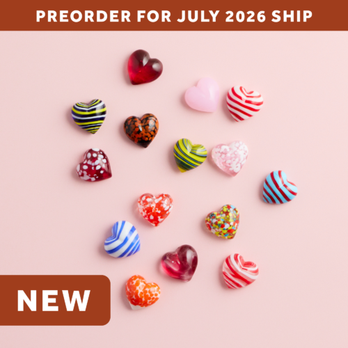 wholesale artisan glass hearts on a pink background. hearts are multicolored with various patterns. text says: preorder for july 2026 ship. NEW.
