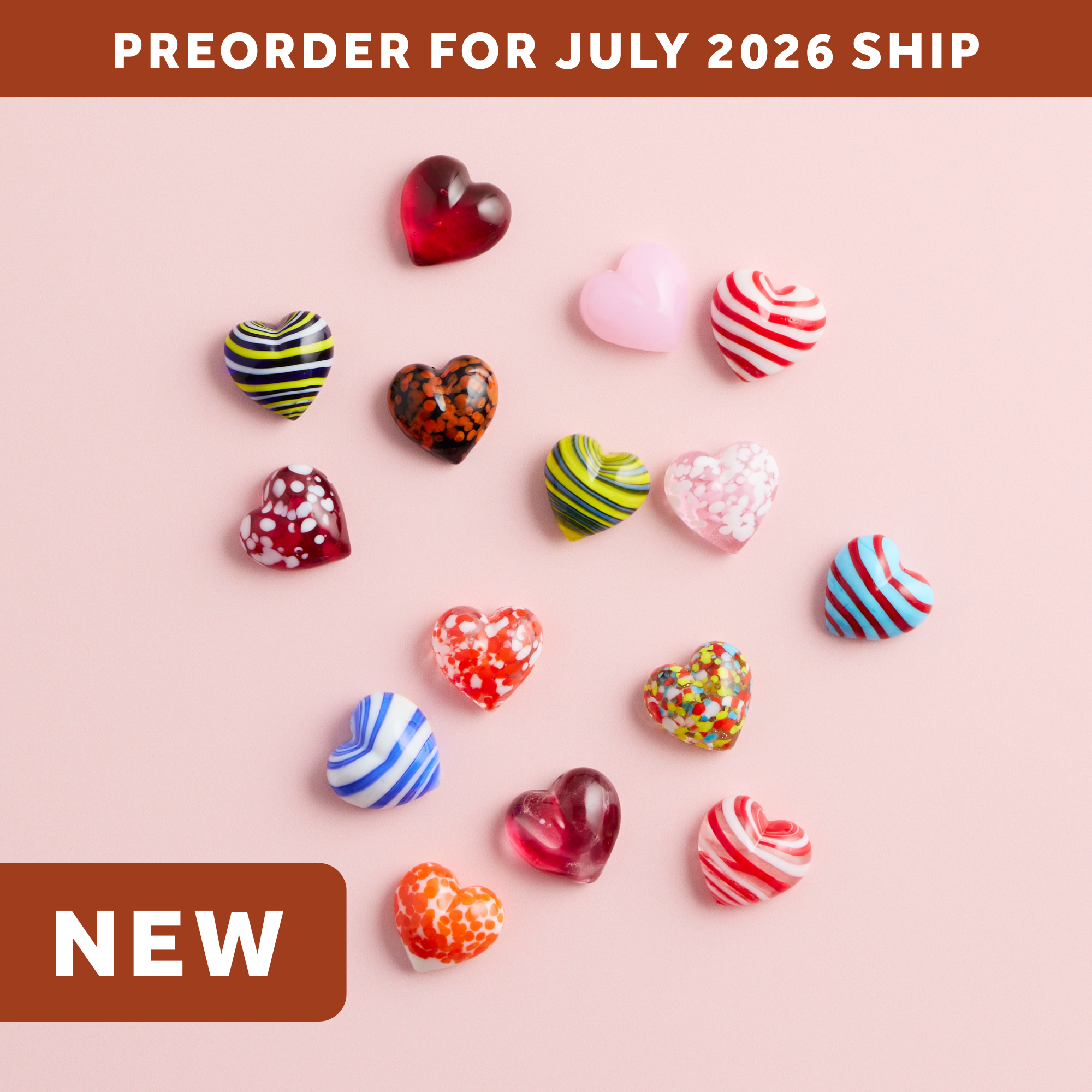 wholesale artisan glass hearts on a pink background. hearts are multicolored with various patterns. text says: preorder for july 2026 ship. NEW.