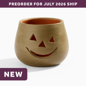 wholesale halloween gray clay jack o lantern candle holder featuring a smiling face with triangle eyes and a triangle nose. text says: preorder for july 2026 ship. NEW.