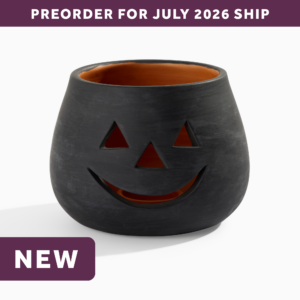 wholesale halloween black clay jack o lantern candle holder featuring a smiling face with triangle eyes and a triangle nose. text says: preorder for july 2026 ship. NEW.